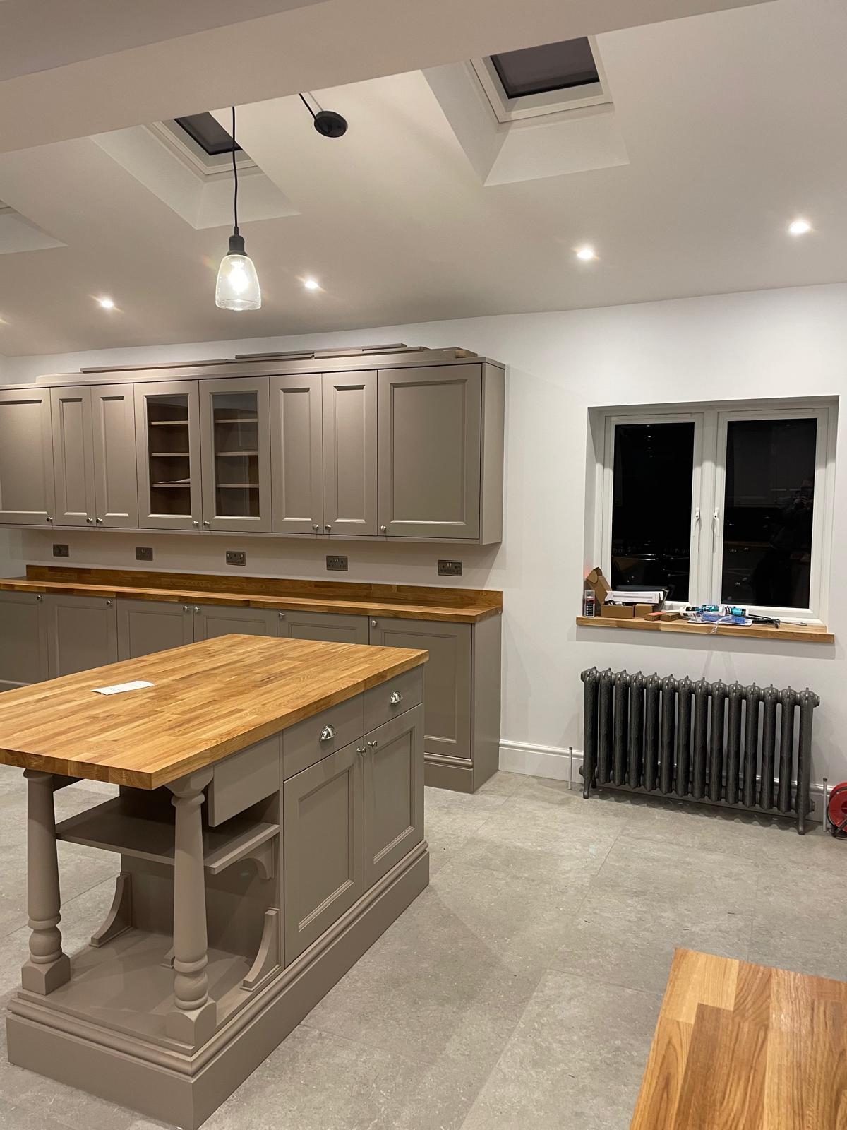 Modern kitchen island and fitted kitchen completed by Gary Taylor and Company