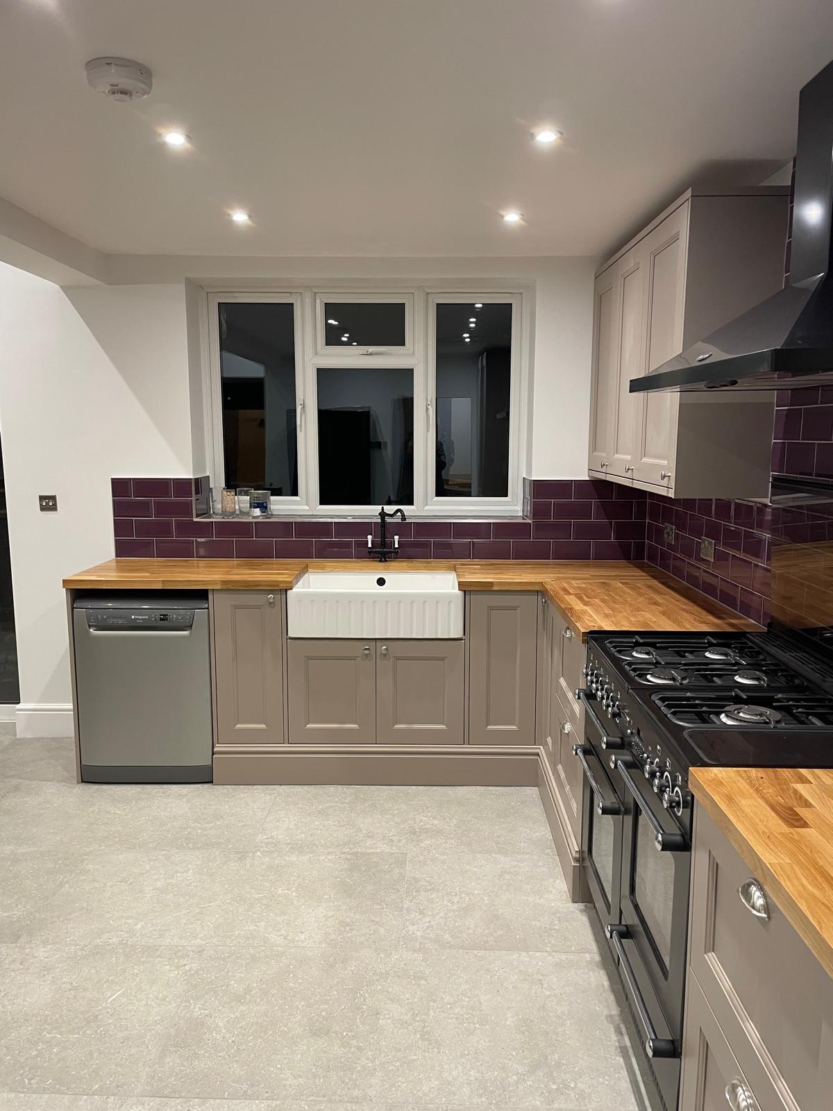 Modern fitted kitchen with tiled flooring