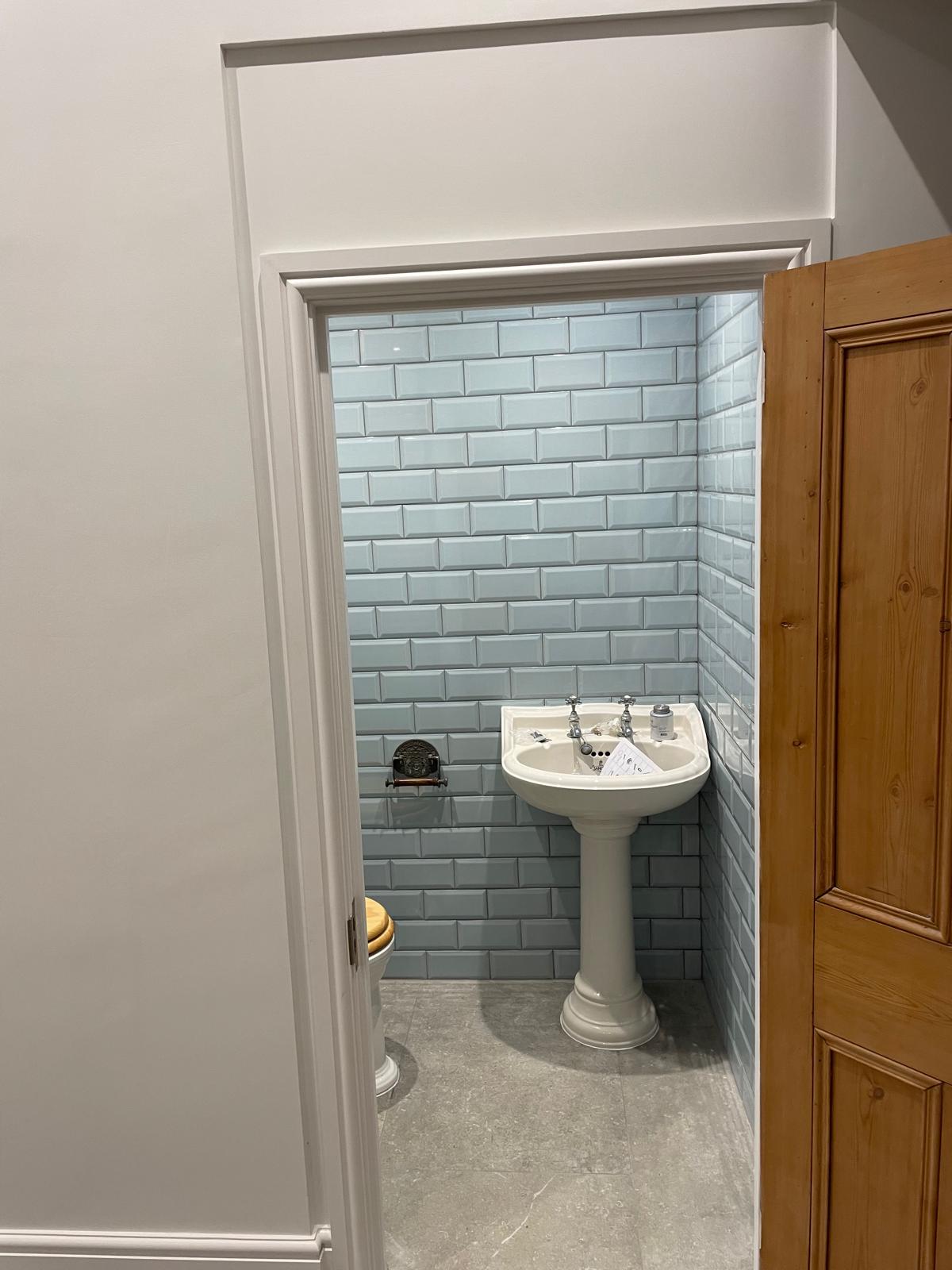 Small bathroom renovation with tiled walls