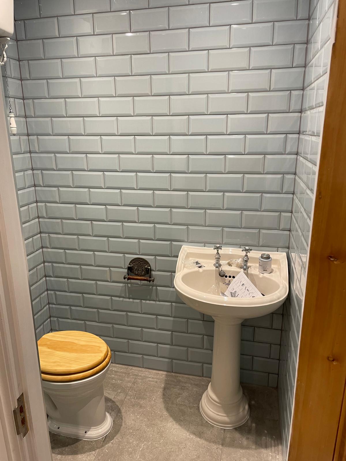 Bathroom suite with sink toilet and grey tiles